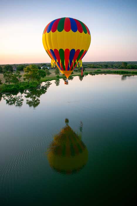Hot air ballooning over a lake in Austin, TX.